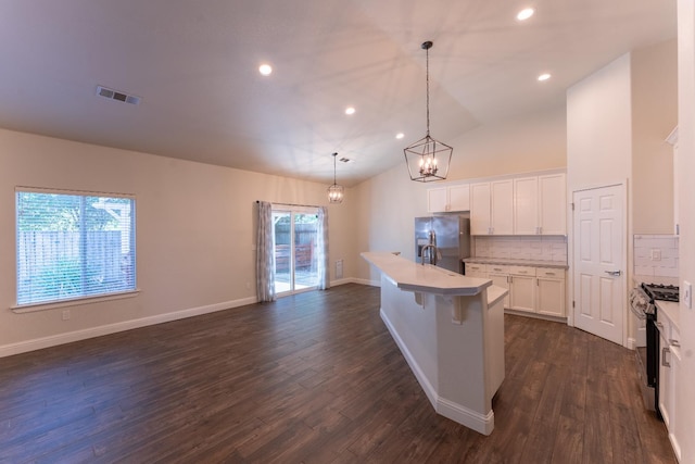 1963 Rialto Ct, Clovis, CA 93611 - kitchen with gas range, stainless steel refrigerator with ice dispenser, light countertops, dark wood finished floors, and white cabinets