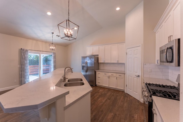 1963 Rialto Ct, Clovis, CA 93611 - kitchen featuring stainless steel appliances, light countertops, white cabinets, vaulted ceiling, and dark wood finished floors