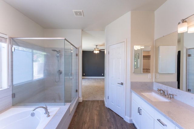 1963 Rialto Ct, Clovis, CA 93611 - full bath with ceiling fan, vanity, a shower stall, wood finished floors, and a garden tub