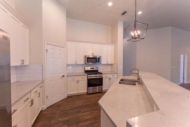 1963 Rialto Ct, Clovis, CA 93611 - kitchen featuring appliances with stainless steel finishes, white cabinetry, backsplash, and recessed lighting