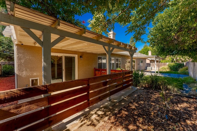 1963 Rialto Ct, Clovis, CA 93611 - back of property with stucco siding, a chimney, a pergola, and a patio