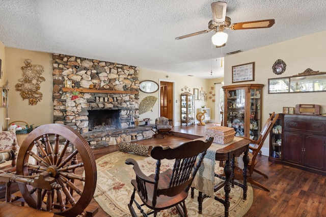 44810 Douglas Rd S, Coarsegold, CA 93614 - living area with a textured ceiling, a ceiling fan, wood finished floors, and a stone fireplace