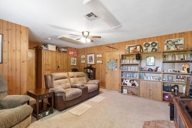 44810 Douglas Rd S, Coarsegold, CA 93614 - living room featuring wooden walls, a ceiling fan, and carpet flooring
