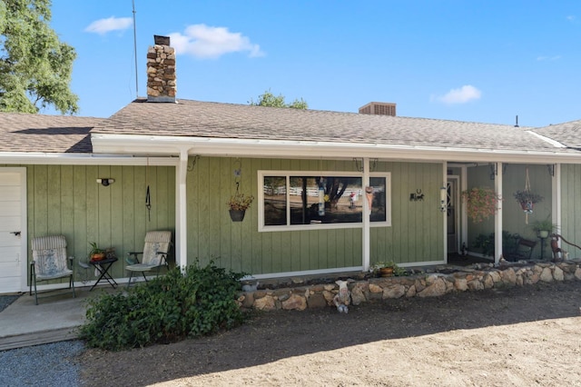 44810 Douglas Rd S, Coarsegold, CA 93614 - property entrance with a chimney, roof with shingles, and a porch