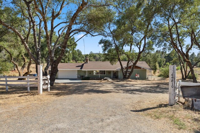 44810 Douglas Rd S, Coarsegold, CA 93614 - single story home with driveway, a chimney, and an attached garage