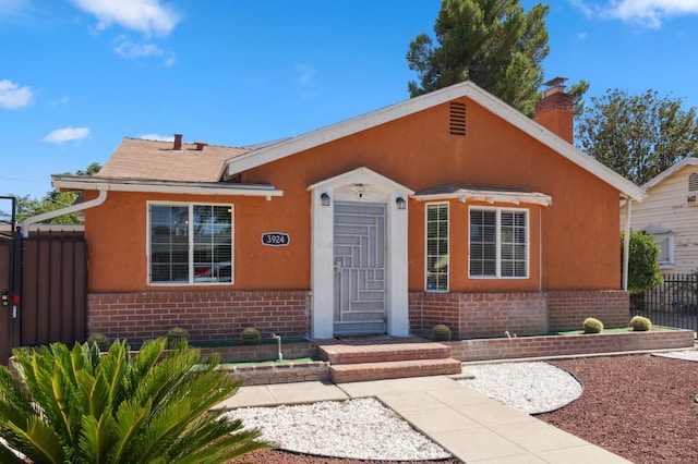 3924 E Iowa Ave, Fresno, CA 93702 - bungalow featuring brick siding, a chimney, and stucco siding