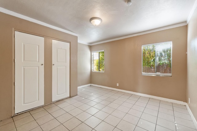 3924 E Iowa Ave, Fresno, CA 93702 - unfurnished bedroom featuring ornamental molding, light tile patterned floors, and a textured ceiling