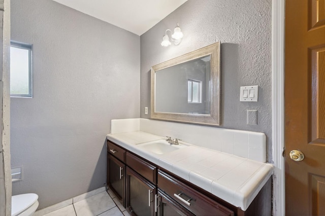3924 E Iowa Ave, Fresno, CA 93702 - bathroom with vanity, tile patterned floors, and a textured wall