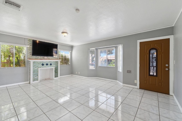 3924 E Iowa Ave, Fresno, CA 93702 - foyer with healthy amount of natural light, light tile patterned floors, crown molding, and a fireplace