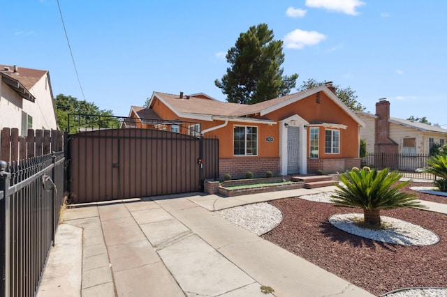 3924 E Iowa Ave, Fresno, CA 93702 - view of front of property featuring brick siding, a gate, and concrete driveway