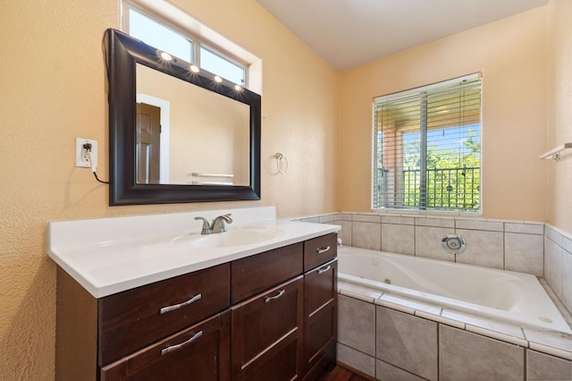 3924 E Iowa Ave, Fresno, CA 93702 - bathroom featuring vanity, a whirlpool tub, healthy amount of natural light, and a textured wall