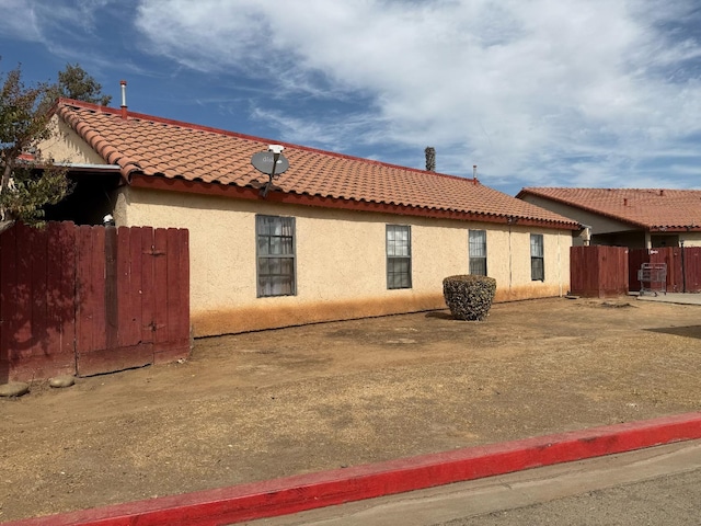1405 E Cypress Ave Unit 137, Reedley, CA 93654 - view of property exterior with a tile roof and stucco siding