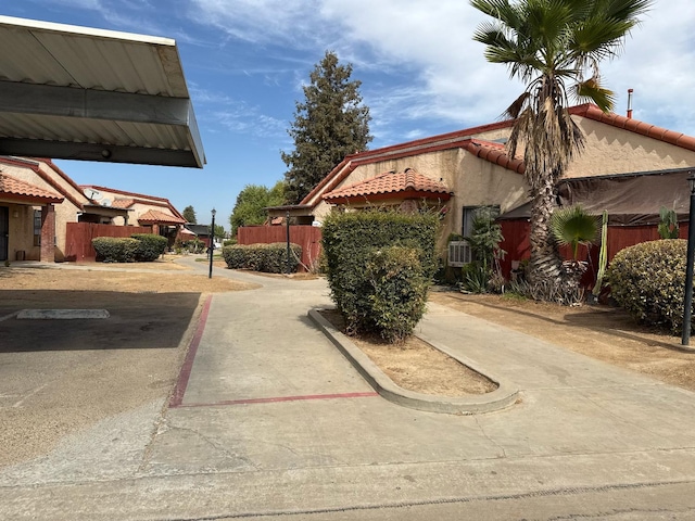 1405 E Cypress Ave Unit 157, Reedley, CA 93654 - view of property exterior featuring a tile roof and stucco siding