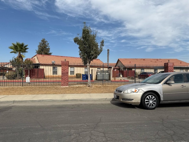 1405 E Cypress Ave Unit 217, Reedley, CA 93654 - view of front of home featuring a tile roof and a fenced front yard