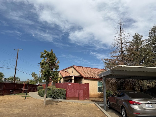 1405 E Cypress Ave Unit 217, Reedley, CA 93654 - view of front of home featuring a tiled roof and stucco siding