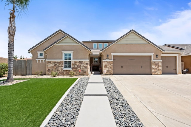 1397 N Redington Ave, Clovis, CA 93619 - craftsman-style house featuring stone siding, stucco siding, an attached garage, and concrete driveway