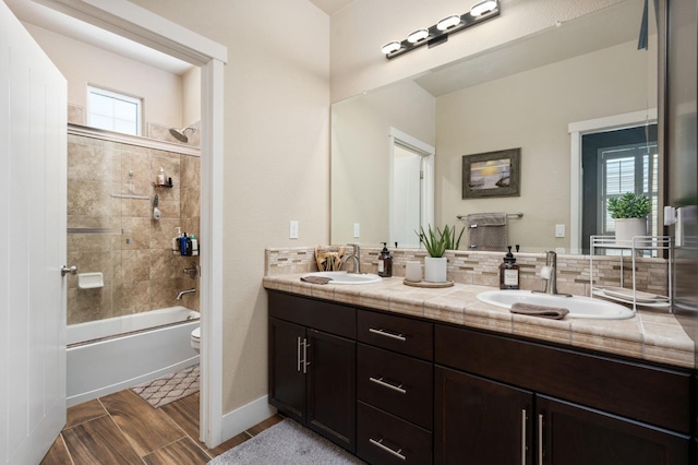 1397 N Redington Ave, Clovis, CA 93619 - full bathroom featuring double vanity, plenty of natural light, shower / bathtub combination, and tasteful backsplash
