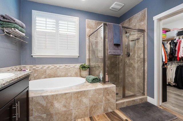 1397 N Redington Ave, Clovis, CA 93619 - full bathroom with a garden tub, a stall shower, a walk in closet, and vanity
