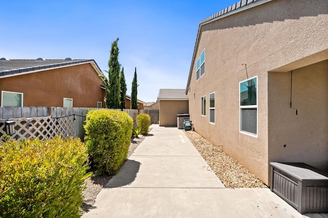 1397 N Redington Ave, Clovis, CA 93619 - view of property exterior with stucco siding and a patio area