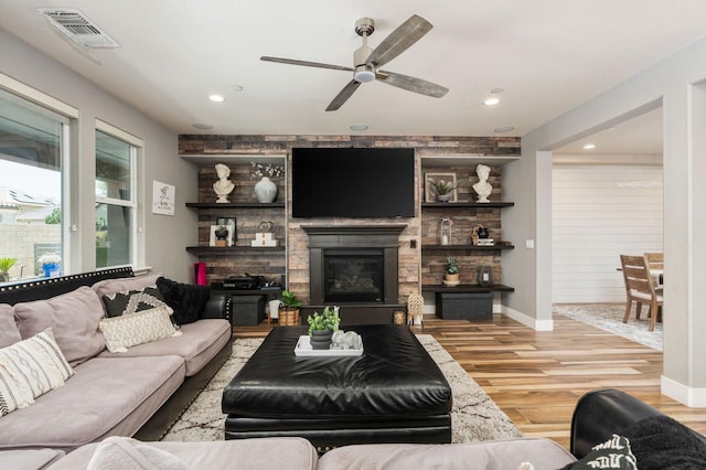 1397 N Redington Ave, Clovis, CA 93619 - living room featuring a ceiling fan, wood finished floors, a glass covered fireplace, and recessed lighting