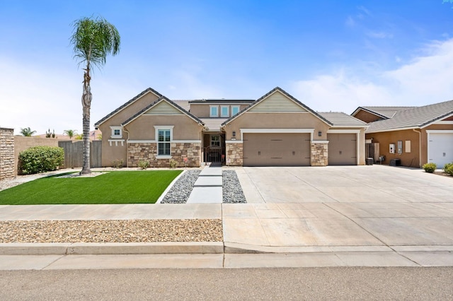 1397 N Redington Ave, Clovis, CA 93619 - craftsman house featuring an attached garage, stucco siding, driveway, and stone siding