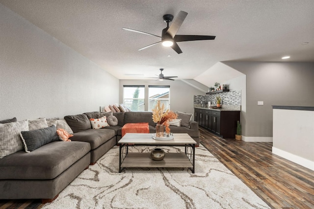 1397 N Redington Ave, Clovis, CA 93619 - living room with dark wood-type flooring, ceiling fan, a textured ceiling, vaulted ceiling, and a bar