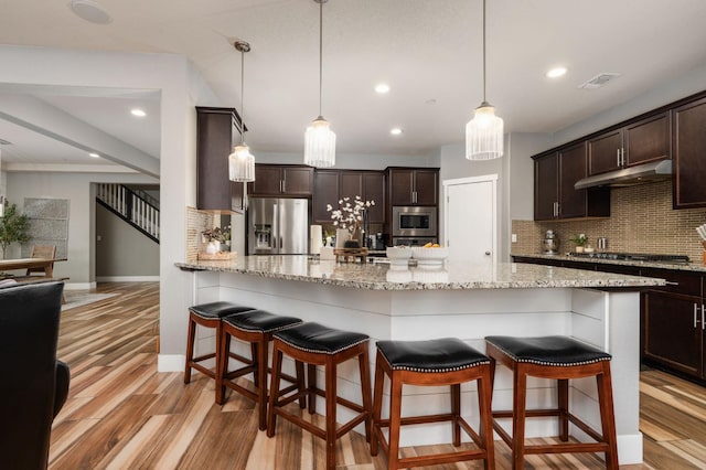 1397 N Redington Ave, Clovis, CA 93619 - kitchen featuring stainless steel appliances, tasteful backsplash, dark brown cabinetry, light wood-style floors, and recessed lighting