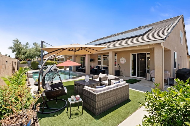 1397 N Redington Ave, Clovis, CA 93619 - rear view of property featuring outdoor lounge area, roof mounted solar panels, stucco siding, a fenced backyard, and a patio area
