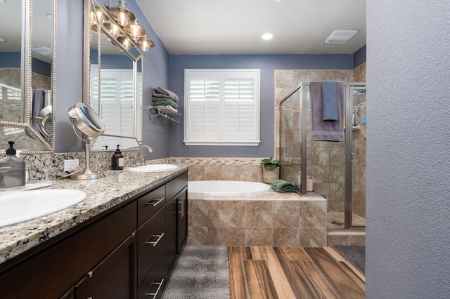1397 N Redington Ave, Clovis, CA 93619 - full bathroom featuring a bath, a shower stall, double vanity, and wood finished floors
