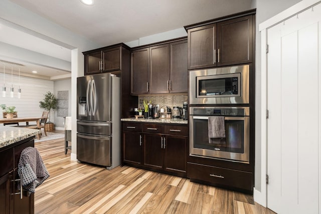 1397 N Redington Ave, Clovis, CA 93619 - kitchen featuring appliances with stainless steel finishes, tasteful backsplash, light wood-type flooring, dark brown cabinets, and recessed lighting