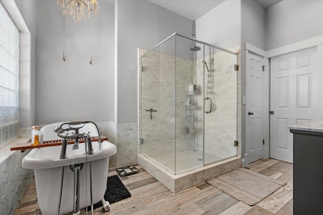 34503 Backbone Rd, Auberry, CA 93602 - full bath featuring wood finished floors, a freestanding bath, a stall shower, a chandelier, and vanity