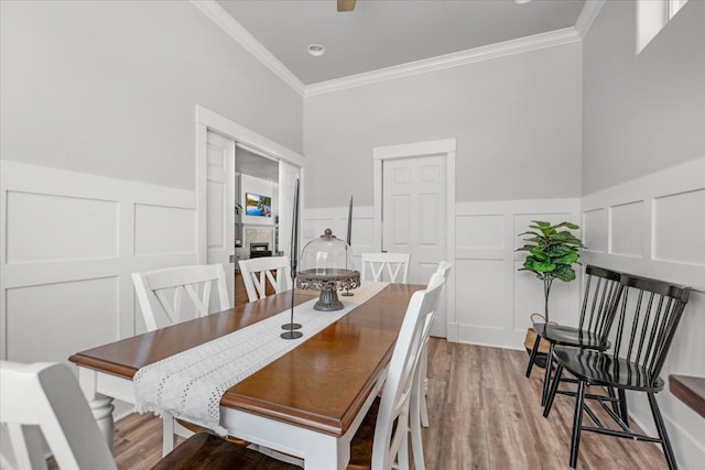 34503 Backbone Rd, Auberry, CA 93602 - dining room with a decorative wall, crown molding, wainscoting, and wood finished floors