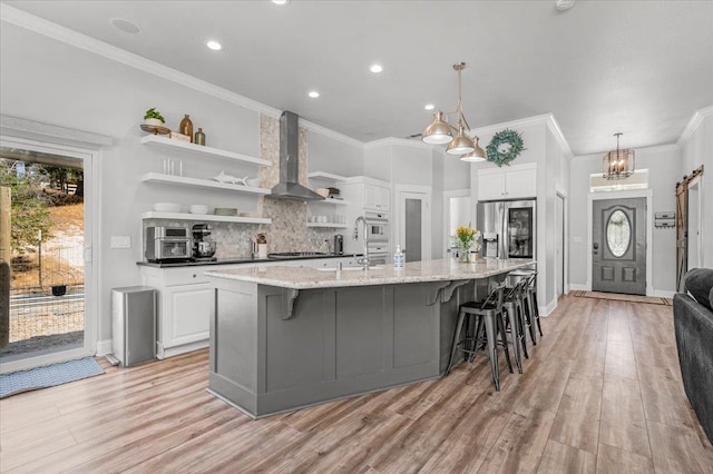 34503 Backbone Rd, Auberry, CA 93602 - kitchen with open shelves, wall chimney exhaust hood, stainless steel fridge with ice dispenser, white cabinetry, and ornamental molding