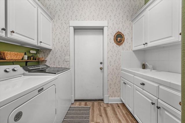 34503 Backbone Rd, Auberry, CA 93602 - laundry area featuring wallpapered walls, washer and dryer, cabinet space, and light wood-type flooring