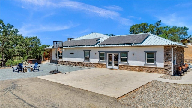 34503 Backbone Rd, Auberry, CA 93602 - rear view of property with french doors, stone siding, solar panels, stucco siding, and a fire pit