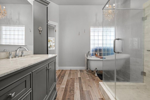 34503 Backbone Rd, Auberry, CA 93602 - full bathroom featuring a chandelier, vanity, a soaking tub, and healthy amount of natural light