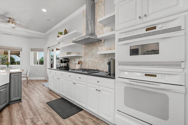 34503 Backbone Rd, Auberry, CA 93602 - kitchen with open shelves, wall chimney exhaust hood, stainless steel gas stovetop, crown molding, and gray cabinets