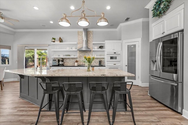 34503 Backbone Rd, Auberry, CA 93602 - kitchen with stainless steel fridge, open shelves, wall chimney exhaust hood, ornamental molding, and white cabinetry