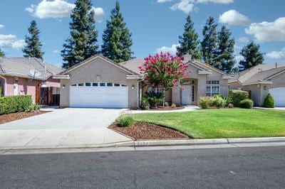 5484 W El Paso Ave, Fresno, CA 93722 - ranch-style house featuring an attached garage, concrete driveway, and a front lawn