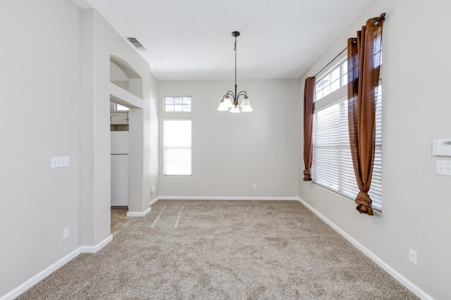 5484 W El Paso Ave, Fresno, CA 93722 - spare room featuring plenty of natural light, a chandelier, and carpet flooring