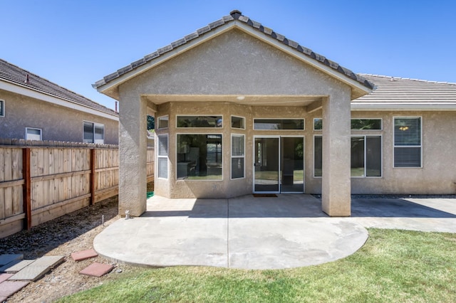 5484 W El Paso Ave, Fresno, CA 93722 - rear view of property featuring stucco siding and a patio