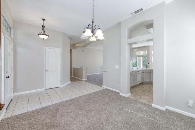 5484 W El Paso Ave, Fresno, CA 93722 - unfurnished dining area featuring light carpet, light tile patterned floors, and a chandelier