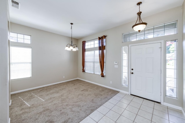 5484 W El Paso Ave, Fresno, CA 93722 - entrance foyer featuring light carpet, a chandelier, and light tile patterned floors