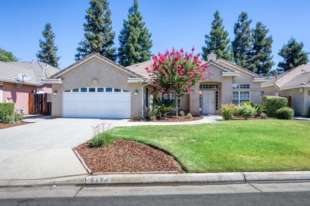 5484 W El Paso Ave, Fresno, CA 93722 - view of front of property featuring a garage, a front yard, concrete driveway, and stucco siding