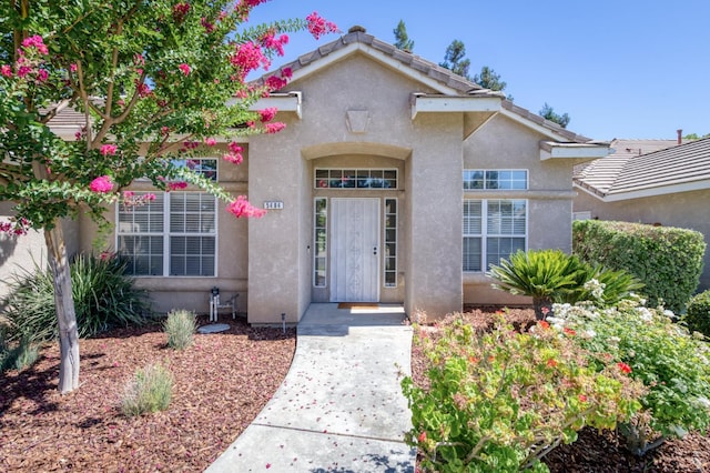 5484 W El Paso Ave, Fresno, CA 93722 - doorway to property featuring stucco siding