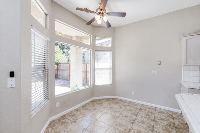 5484 W El Paso Ave, Fresno, CA 93722 - unfurnished dining area featuring ceiling fan and light tile patterned floors