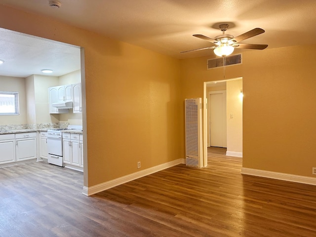 2723 E Lansing Way, Fresno, CA 93726 - unfurnished living room featuring a heating unit, wood finished floors, and ceiling fan