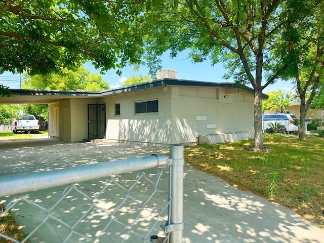2723 E Lansing Way, Fresno, CA 93726 - rear view of house featuring a carport and driveway
