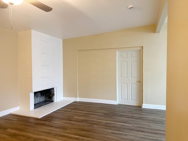 2723 E Lansing Way, Fresno, CA 93726 - unfurnished living room with a ceiling fan, dark wood-type flooring, and a fireplace