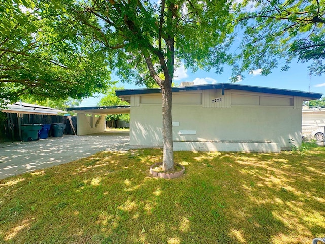 2723 E Lansing Way, Fresno, CA 93726 - view of home's exterior featuring an attached carport, a lawn, and concrete driveway